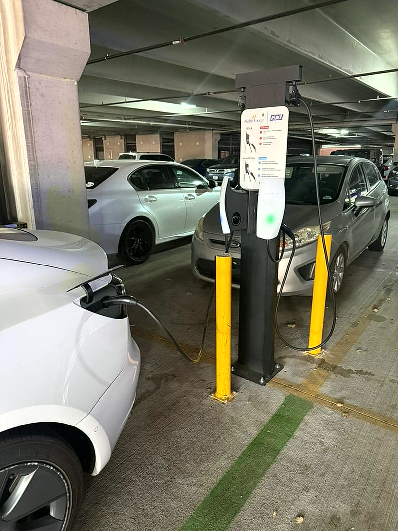 Level 2 charger at Grand Canyon University charging a Tesla in a campus parking garage