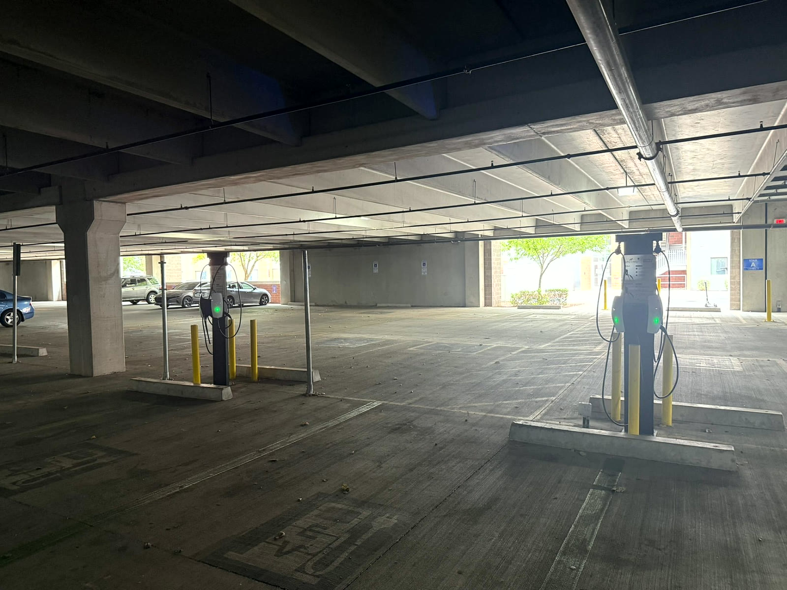 Two Level 2 charging pedestals installed across a Grand Canyon University parking garage